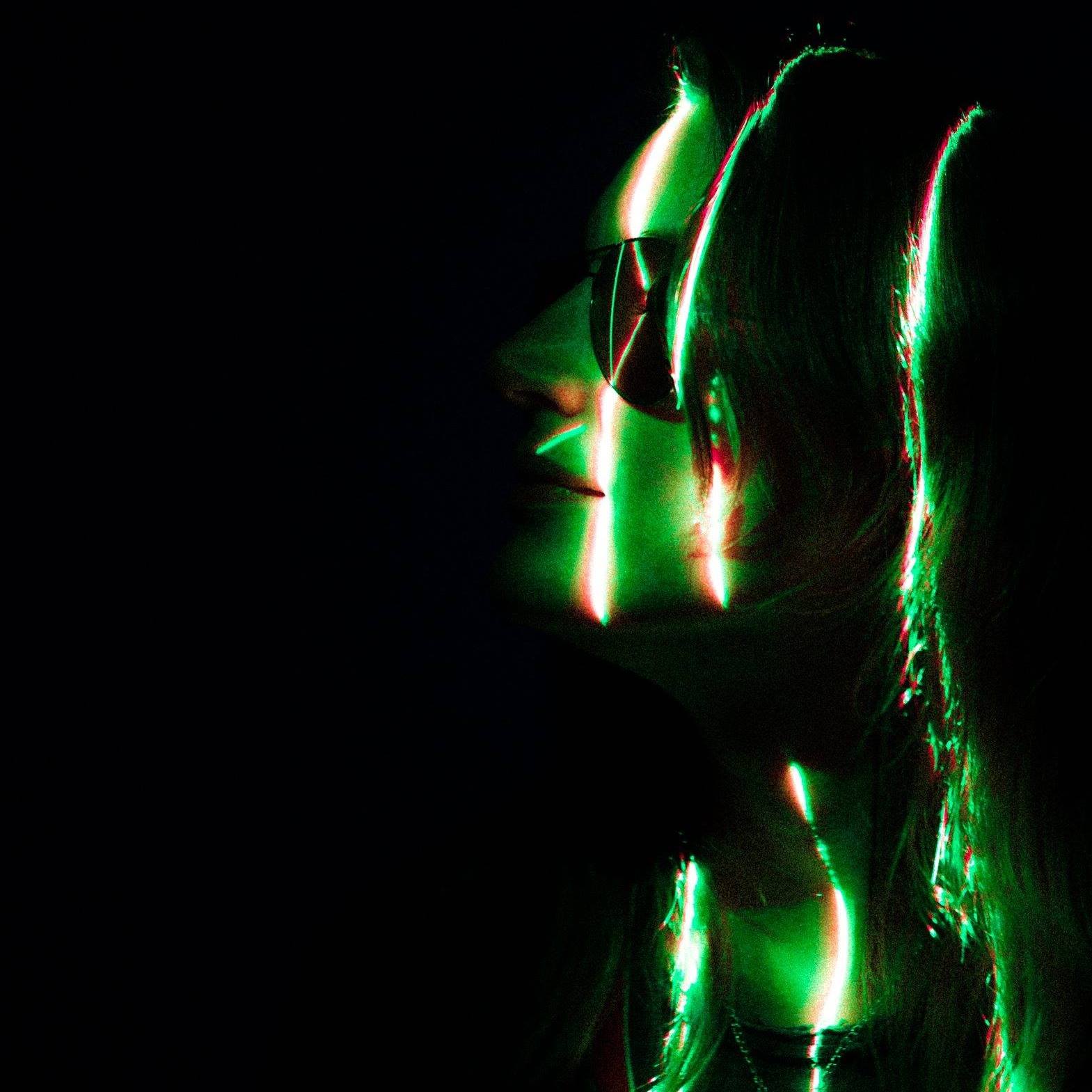 Nancy Dru in profile, lit with green and red prism light